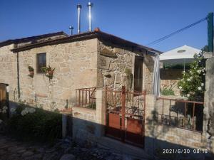 Casa de piedra con porche y balcón en O Cantinho das Lages, en Covas