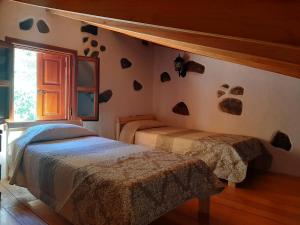 A bed or beds in a room at Casita el Parral