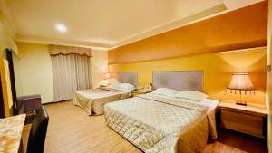 Postel nebo postele na pokoji v ubytování Dong Zhi Gang Motel