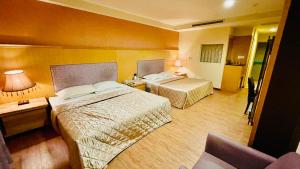 Postel nebo postele na pokoji v ubytování Dong Zhi Gang Motel