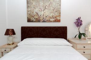 Posteľ alebo postele v izbe v ubytovaní Apartamentos Anfiteatro