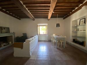 a living room with a white couch and a table at Window to Bagno Vignoni in Bagno Vignoni