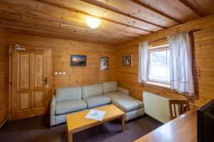 a living room with a couch and a table at Penzion Damisport in Donovaly