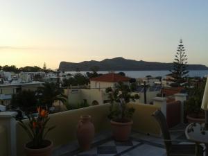 a view of a city from a balcony with plants at Heaven Apartments in Agia Marina Nea Kydonias