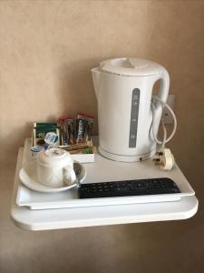 a coffee pot and a keyboard on a shelf at The Maxwell Arms Hotel in Dalbeattie