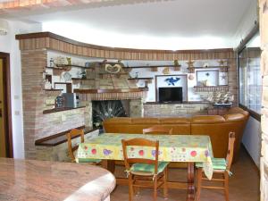 a dining room with a table and a fireplace at Dimora La Conchiglia in Buggerru