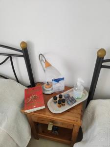 a bedside table with a lamp and cupcakes on it at Fotini & Dimitrios in Frý