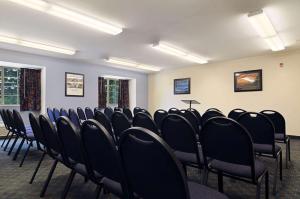a conference room with black chairs in it at Microtel Inn & Suites by Wyndham Estevan in Estevan +38 photos