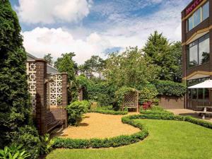 a garden with a gravel path in front of a building at Mercure Norwich Hotel in Norwich