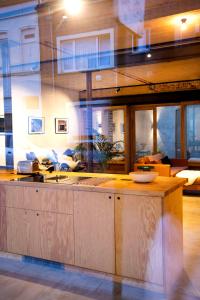 a kitchen with a counter in a living room at Studio73, Guesthouse met sauna in Kortrijk +15 photos
