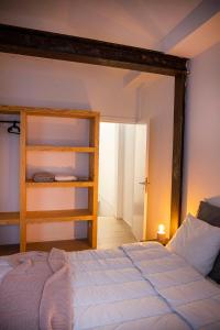 a bedroom with a bed and a book shelf at Studio73, Guesthouse met sauna in Kortrijk