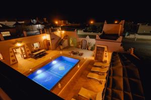 una vista panoramica su una piscina di notte di Hassilabiad Appart Hotel a Merzouga
