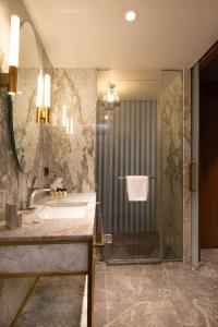 a bathroom with a tub and a shower and a sink at The Craton Hotel Sisli in Istanbul