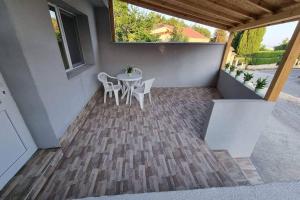 a patio with a table and chairs on a porch at Guest House 59 in Varna City