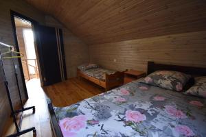 a bedroom with a bed in a wooden cabin at Коттедж Злата in Svityazʼ