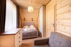 a bedroom with a bed and a desk and a chair at Pod Brzozka in Cisna