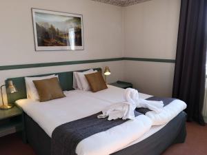 Postel nebo postele na pokoji v ubytování Hotell Älvdalen