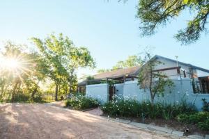 a white house with the sun in the background at Home in Cape Town-The Homestead in Stellenbosch
