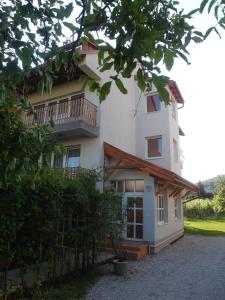 a building with a balcony on the side of it at Tip-Top Apartmenthouse in Balatonfüred