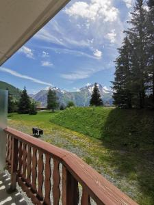d'un balcon avec vue sur un champ et les montagnes. dans l'établissement Boost Your Immo Les Deux Alpes Le Midi 502, à Les Deux Alpes