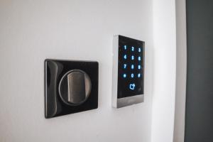 a remote control on a wall with a clock on it at La Maison Mickael in Marseille