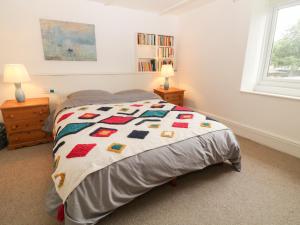 a bedroom with a bed with a quilt on it at 3 West Street in Tiverton