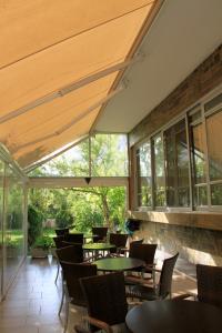 a restaurant with tables and chairs and windows at Hotel Platon in Athens