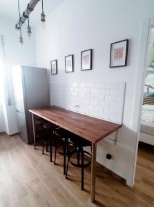 a kitchen with a wooden table and stools at Skyline #Downtown in Civitavecchia