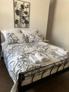 a bedroom with a bed with towels on it at Domek pod lasem in Kołczygłowy