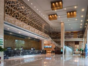 a lobby of a shopping mall with people in it at Vinenna International Hotel Shenzhen shajing in Bao'an