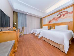Postel nebo postele na pokoji v ubytování Vienna Hotel Hubei Xiangyang Tanxi Road
