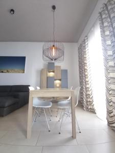 a dining room with a table and chairs at Ayla Studio House I Seaside Cosy and Modern in Birżebbuġa