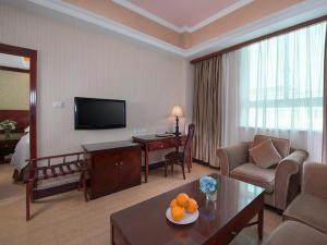 a hotel room with a living room with a living room at Vienna Hotel Nanchang Railway Staion in Nanchang