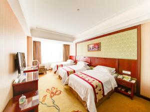 Postel nebo postele na pokoji v ubytování Vienna Hotel Shanghai Jiading New City