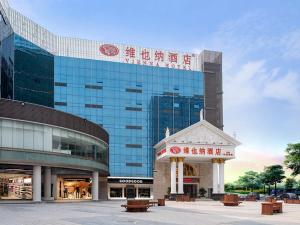 a shopping center with a large glass building at Vienna Hotel Shenzhen Shiyan Shilong Community in Bao'an