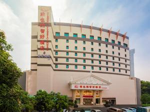 a large building with a sign on top of it at Vienna Hotel Mix City in Shenzhen