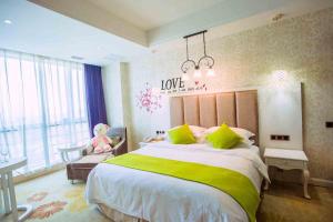 a bedroom with a large bed with a teddy bear in a chair at Vienna International Hotel Fuzhou Cangshan Longfu in Fuzhou
