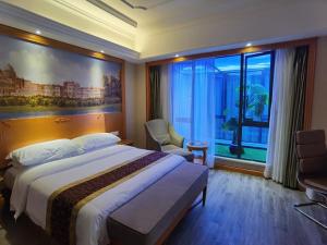 a hotel room with a bed and a large window at Vienna Hotel Shanghai Yangpu Wujiaochang in Shanghai