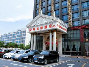 a group of cars parked in front of a building at Vienna Hotel Foshan Airport in Foshan