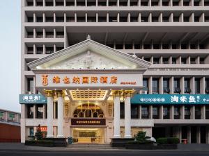 a building with an entrance in front of it at Vienna Hotel Shiyan Guangming Road in Bao'an