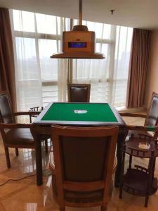 a ping pong table in a dining room with chairs at Vienna International Hotel Dongguan Chang'an North Station in Dongguan