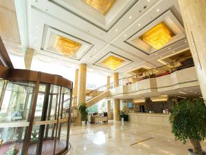 duży hol z klatką schodową w budynku w obiekcie Vienna International Hotel Zhangjiajie Tianmen Mountain w mieście Zhangjiajie