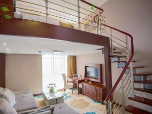 a living room with a loft bed and a living room with a television at Vienna Hotel Suzhou fairyland in Suzhou