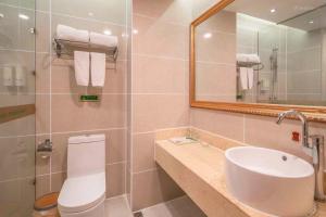 a bathroom with a sink and a toilet and a mirror at Vienna Hotel Guangzhou Yuexiu West Huifu Road in Guangzhou