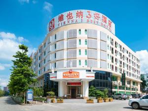 a large white building with a sign on it at Vienna 3 Best Hotel Shenzhen Pinghu Fumin Road in Longgang