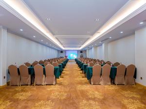a large room with chairs and a stage in it at Vienna Hotel Wuhan Panlong City in Wuhan