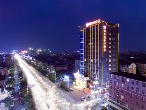 a tall building with lights on top of it at night at Vienna Classic Hotel Nanchang Jiefang West Road in Nanchang