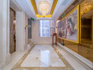 a hallway of a building with a large painting on the wall at Vienna Hotel Wuhan Panlong City in Wuhan