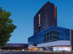 a tall building with lights on the side of it at Vienna Hotel Nanchang Ruzi Road in Nanchang