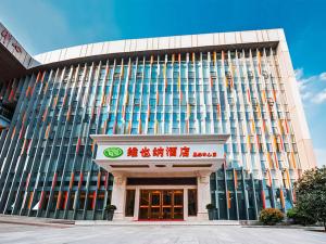 a building with a sign in front of it at Vienna Hotel Nanjing Olympic Sports Center in Nanjing